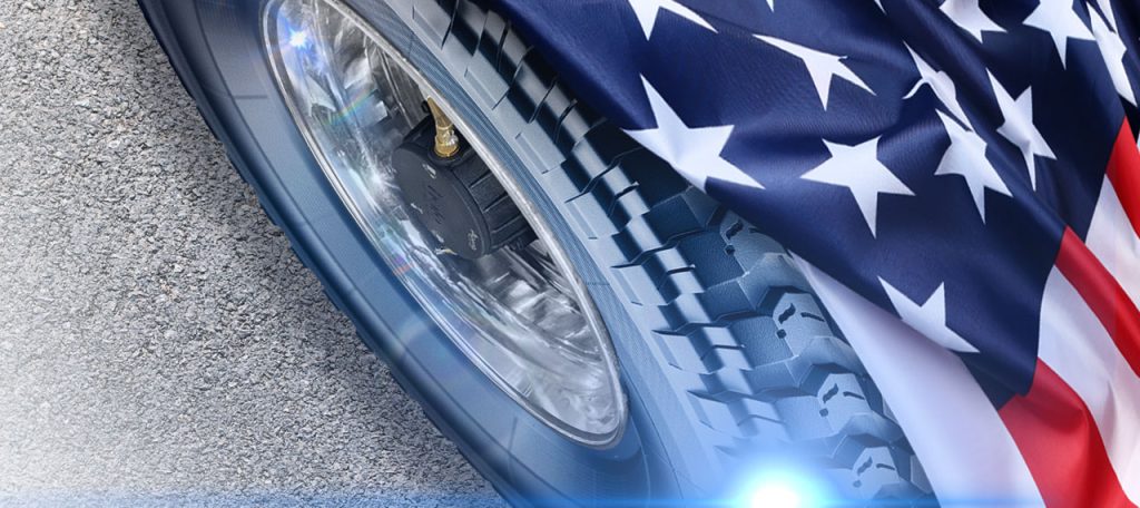 A tire with a Halo Tire Inflator behind an American Flag