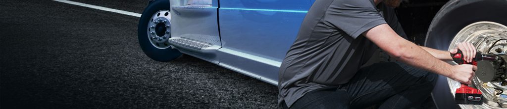 A man installing a Halo Tire Inflator on a truck wheel